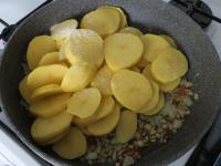 Die Kartoffeln zu der gebratenen Zwiebel geben,...